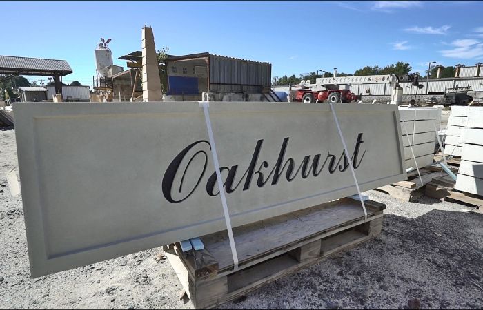 Concrete signage created using precast adhesives to create a more complex mould