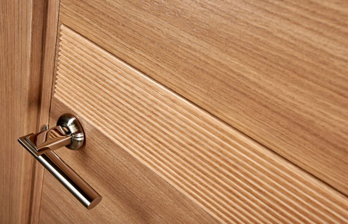 Closeup photo of brown wooden door with metal handle
