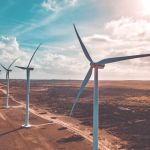 Wind turbines along a section of dirt road
