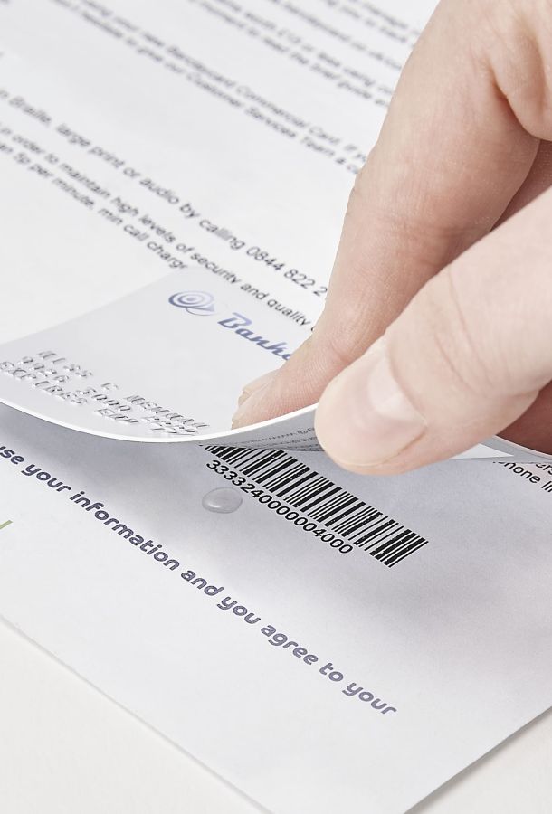 Person removing credit card for the bottom of a letter