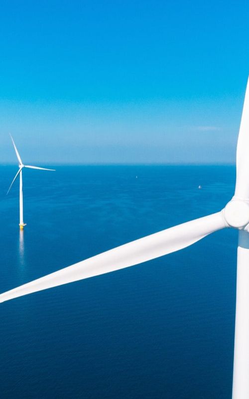 Offshore wind farm with a bright blue sky behind