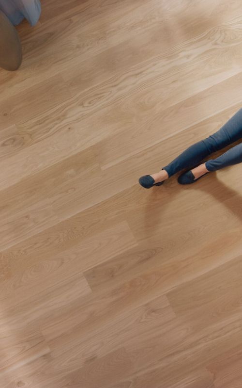 Young woman is sitting on a floor and reading a book