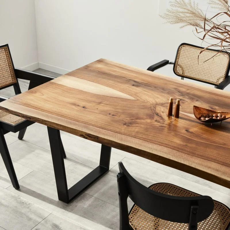 Large modern looking dining table with ornate chairs around it